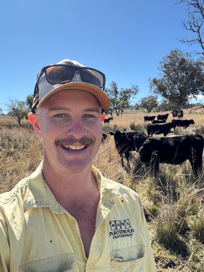 Martin Murray in a paddock with cattle